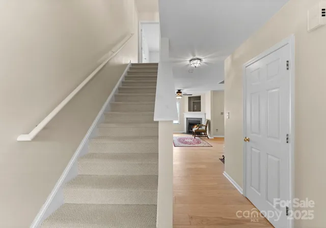 a view of a hallway view with staircase and kitchen view