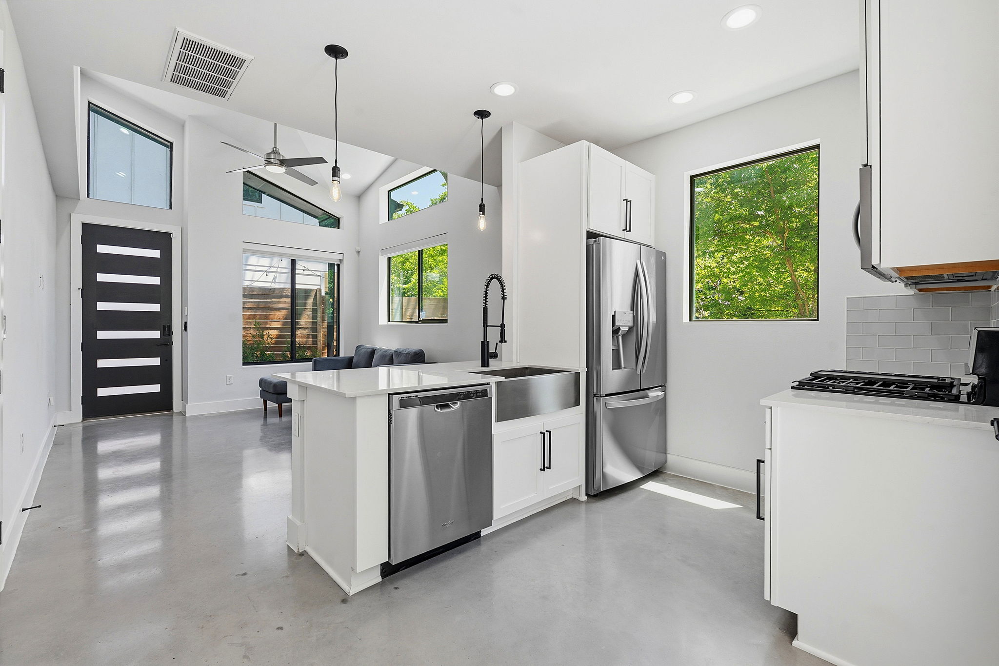 2935 Moss Street, Unit 2 Austin, TX 78722 - Photo 2 of 20 A contemporary open-concept space features vaulted ceilings and ample natural light.