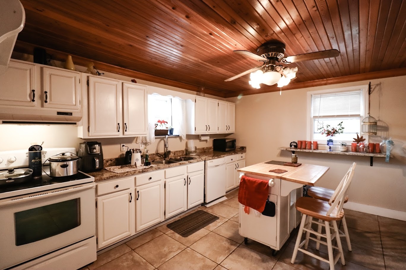 35 Monroe Avenue Charleston, IL 61920 - Photo 13 of 23 a kitchen with a sink a stove cabinets and white stainless steel appliances