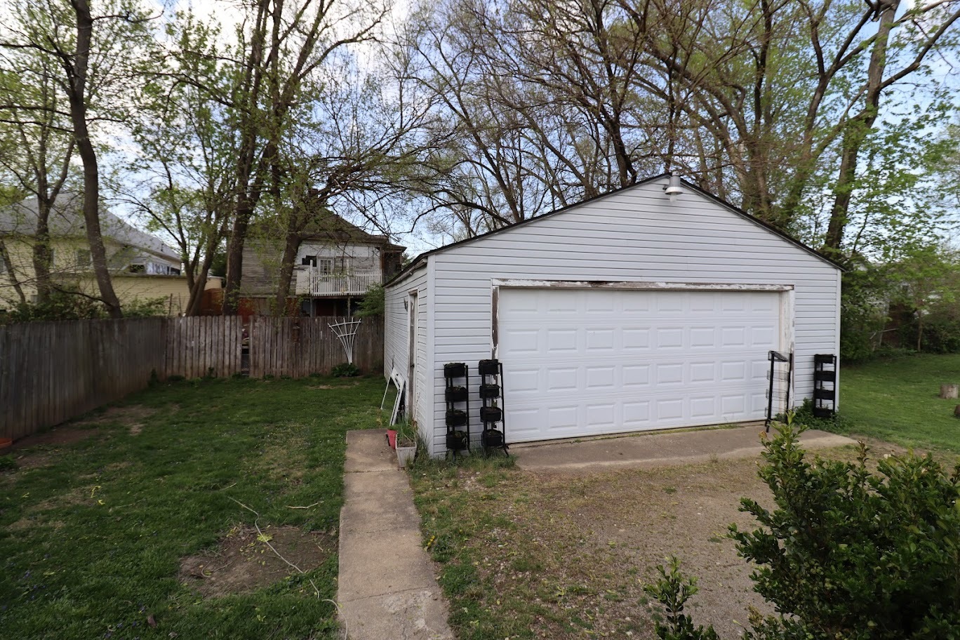 35 Monroe Avenue Charleston, IL 61920 - Photo 21 of 23 a front view of a house with a yard and garage