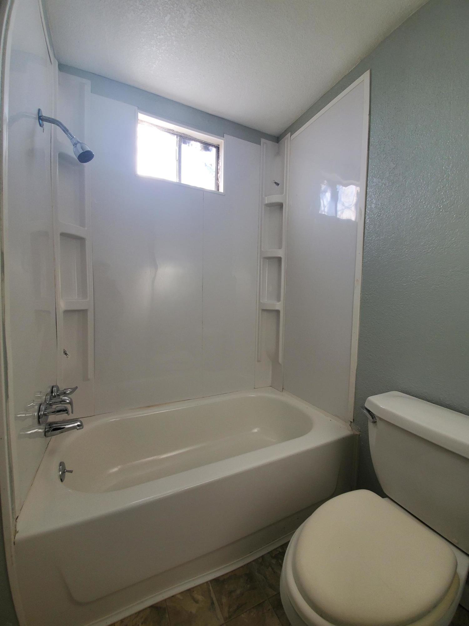 9630 Highway 41 Lemoore, CA 93245 - Photo 7 of 10 a white toilet sitting next to a bath tub