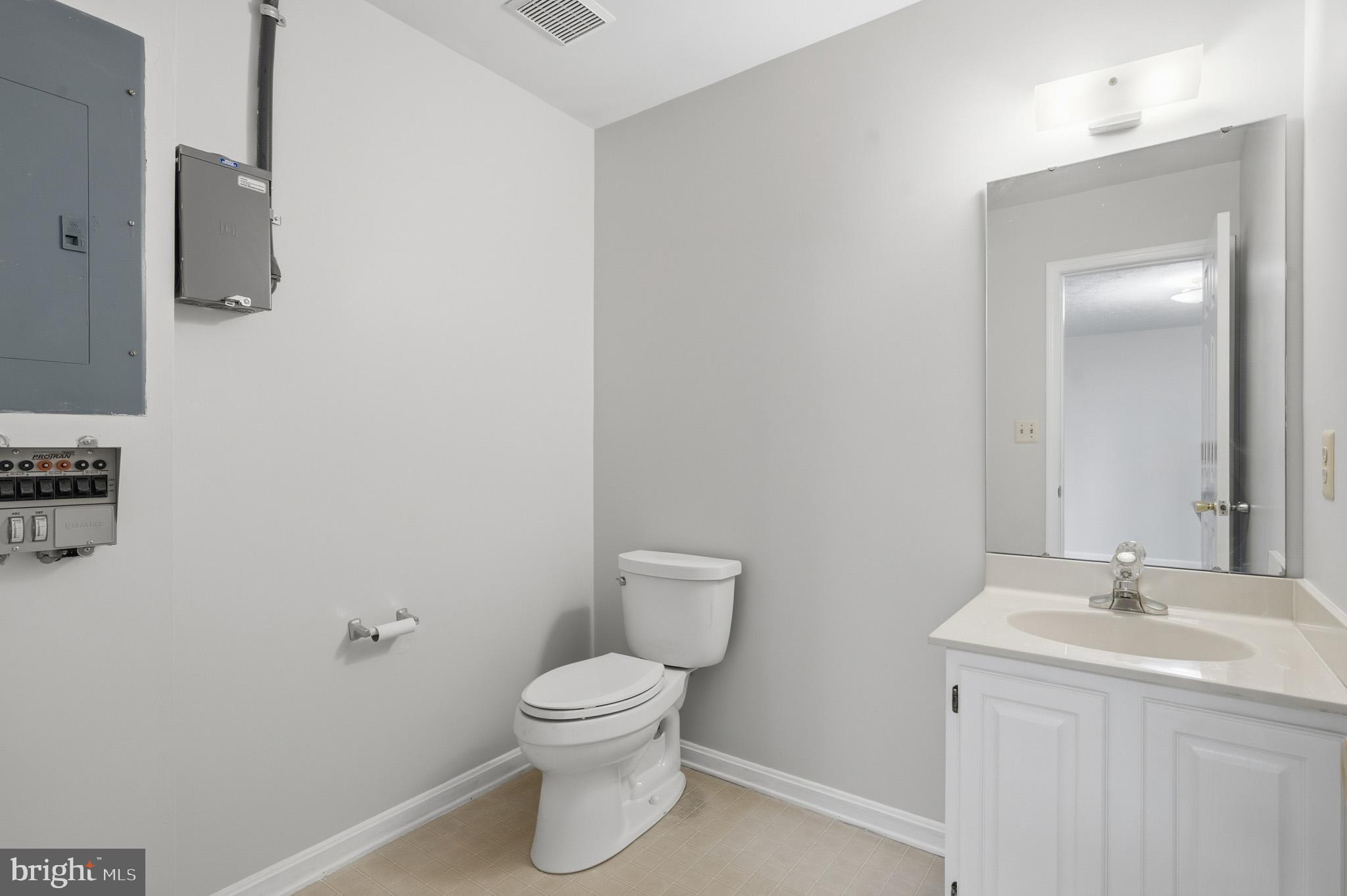9146 Hardesty Drive Clinton, MD 20735 - Photo 11 of 47 a bathroom with a toilet sink and mirror