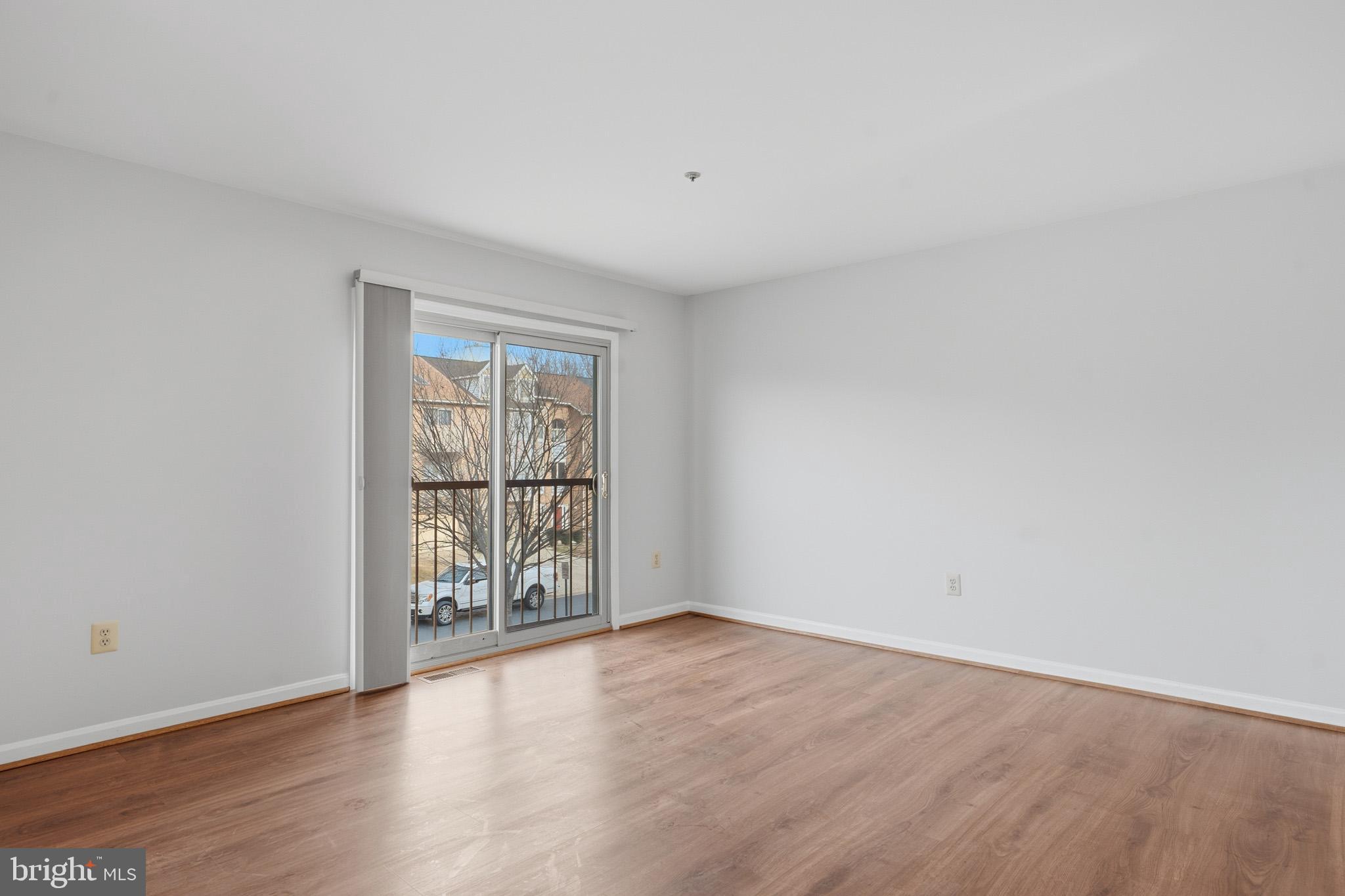 9146 Hardesty Drive Clinton, MD 20735 - Photo 14 of 47 a view of an empty room with wooden floor and a window