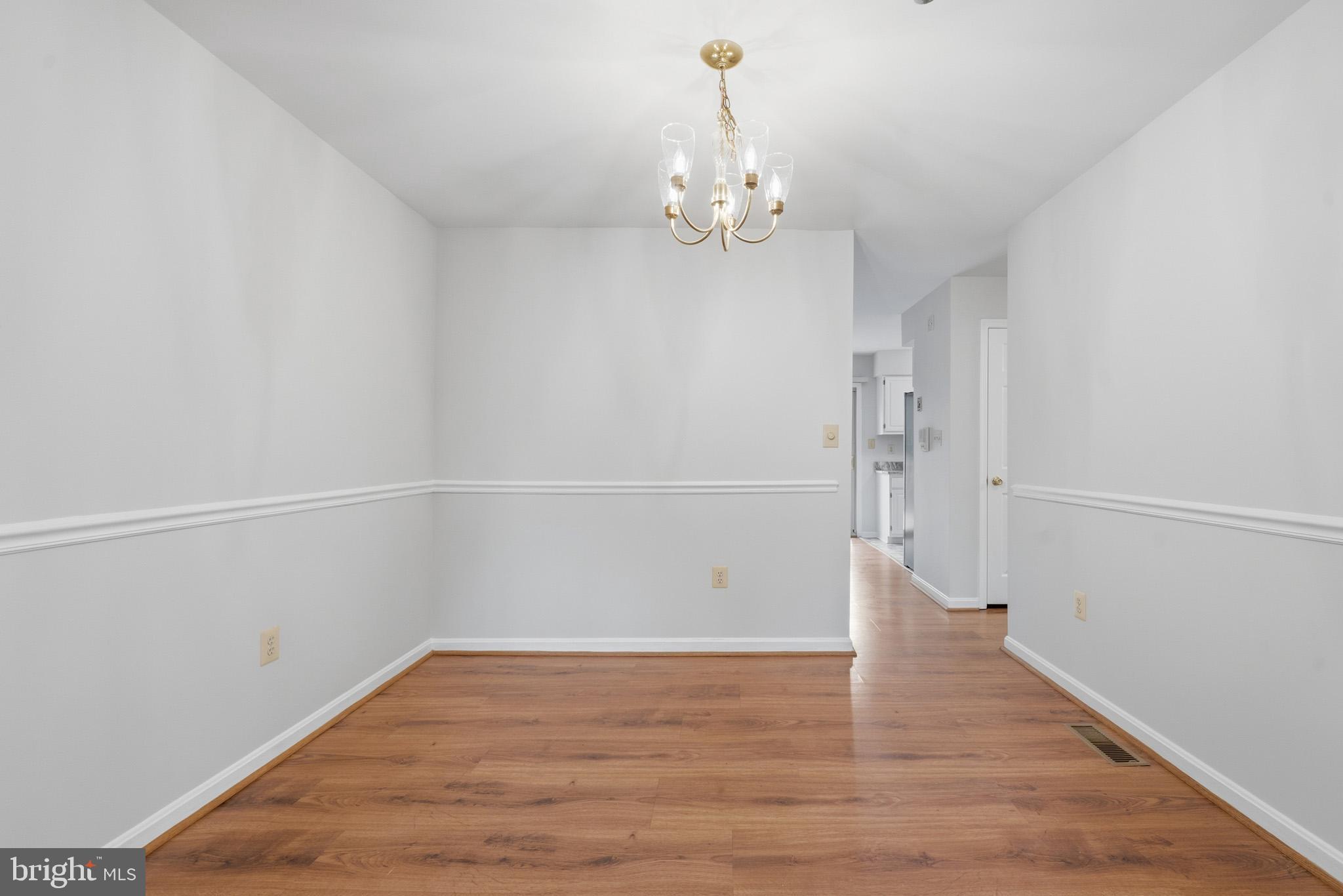 9146 Hardesty Drive Clinton, MD 20735 - Photo 17 of 47 a view of a room with wooden floor and ceiling fan