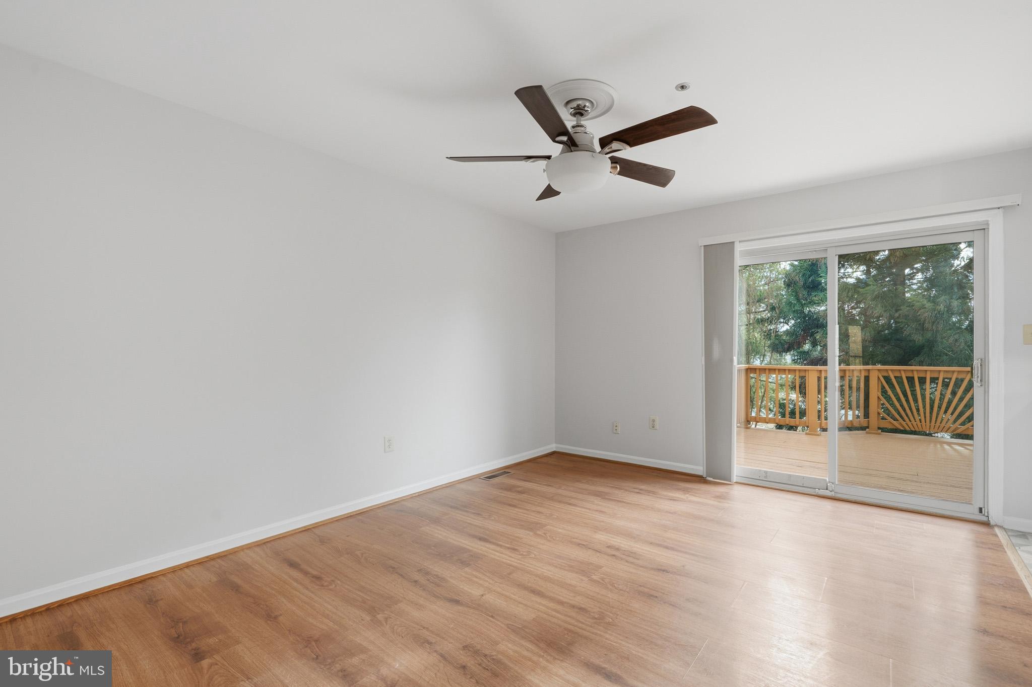 9146 Hardesty Drive Clinton, MD 20735 - Photo 19 of 47 an empty room with wooden floor and windows