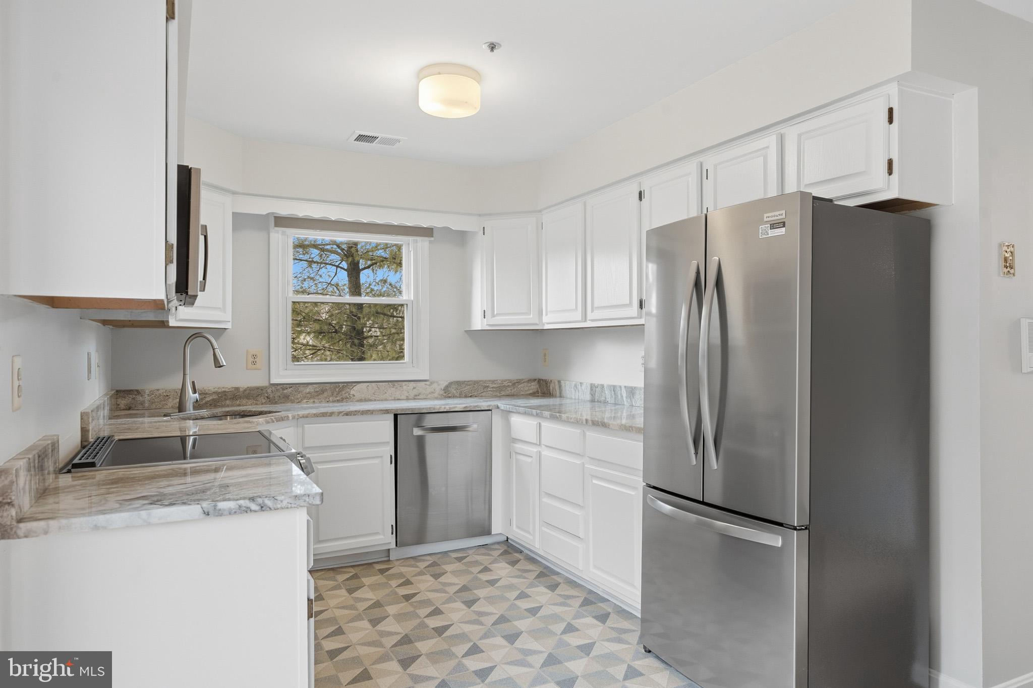 9146 Hardesty Drive Clinton, MD 20735 - Photo 22 of 47 a kitchen with a refrigerator sink and cabinets