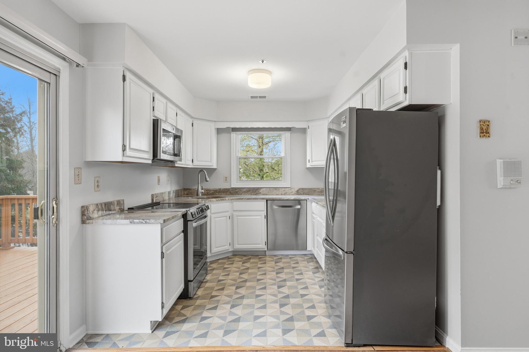9146 Hardesty Drive Clinton, MD 20735 - Photo 23 of 47 a kitchen with a refrigerator and a stove top oven