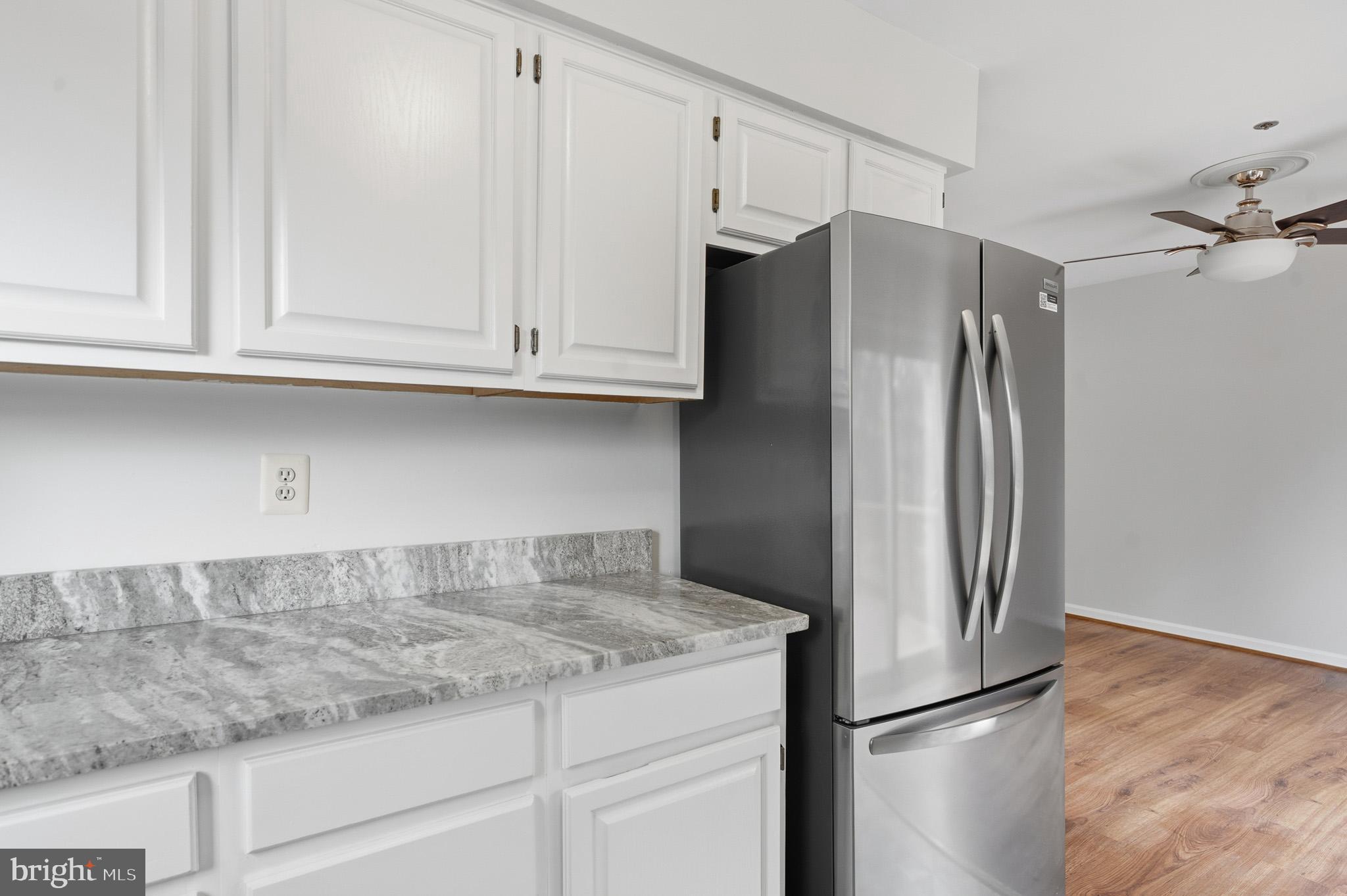 9146 Hardesty Drive Clinton, MD 20735 - Photo 25 of 47 a kitchen with granite countertop a refrigerator and cabinets