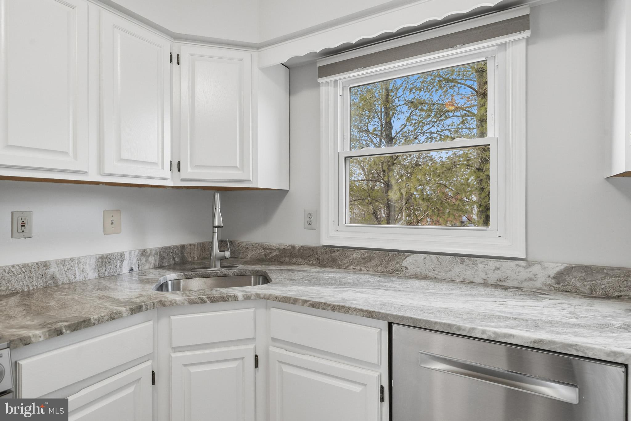 9146 Hardesty Drive Clinton, MD 20735 - Photo 26 of 47 a kitchen with granite countertop stainless steel appliances white cabinets and a window