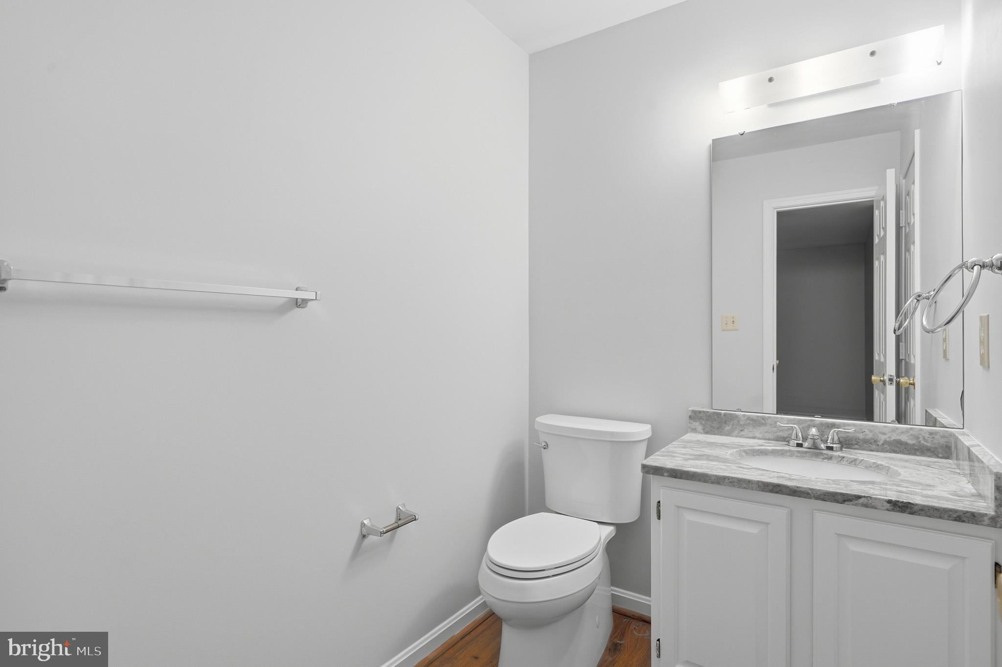 9146 Hardesty Drive Clinton, MD 20735 - Photo 30 of 47 a bathroom with a granite countertop toilet and sink