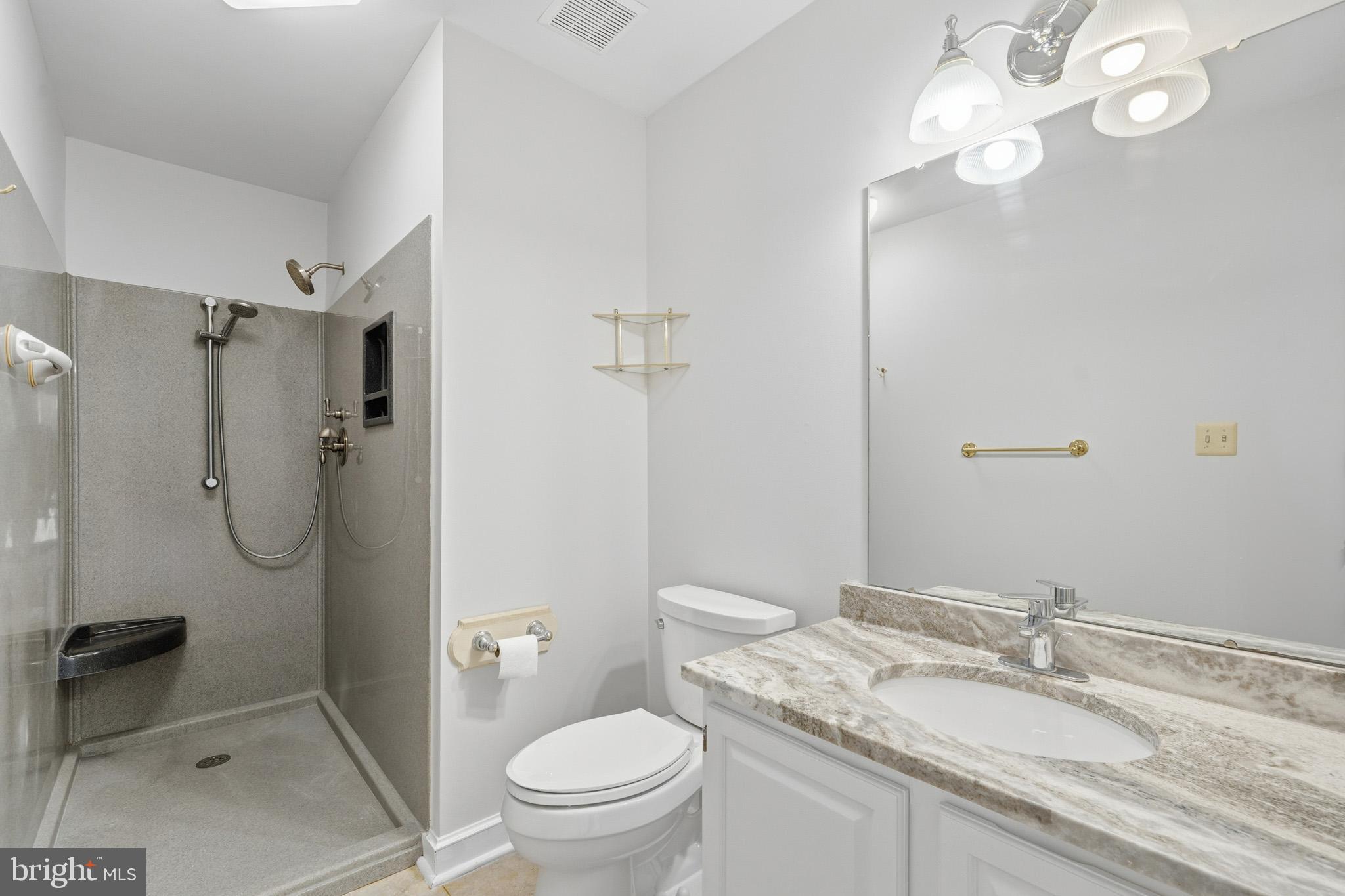 9146 Hardesty Drive Clinton, MD 20735 - Photo 34 of 47 a bathroom with a granite countertop sink toilet and shower