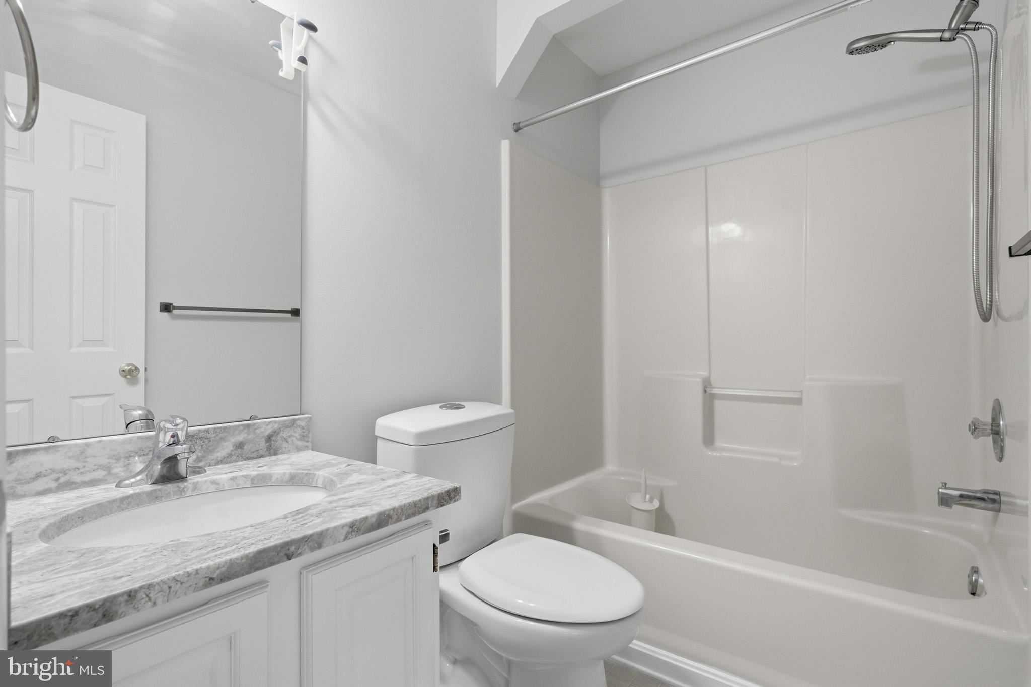 9146 Hardesty Drive Clinton, MD 20735 - Photo 40 of 47 a bathroom with a granite countertop sink toilet and shower