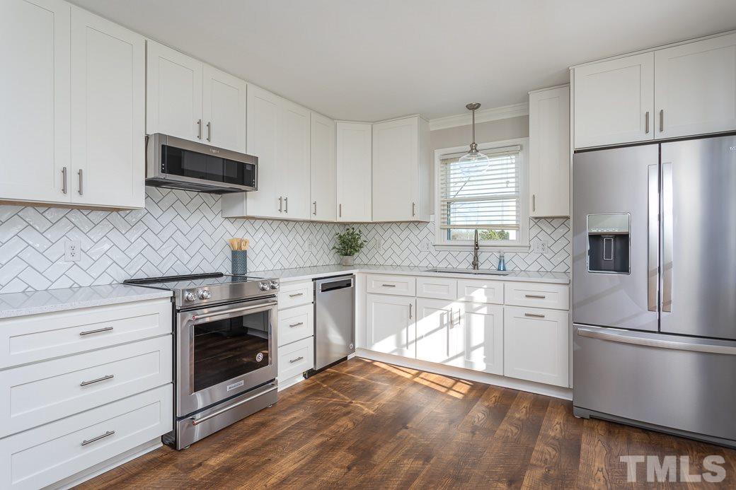 6200 Jones Farm Road Wake Forest, NC 27587 - Photo 8 of 20 NEW Quartz counter tops, tile backsplash and soft-close drawers and doors!