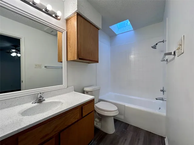 a bathroom with a sink a toilet and bathtub