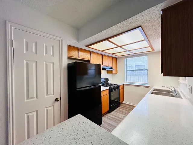 a kitchen with stainless steel appliances granite countertop a refrigerator and a sink