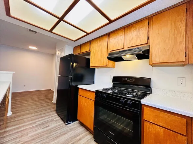a kitchen with stainless steel appliances granite countertop a stove and a refrigerator