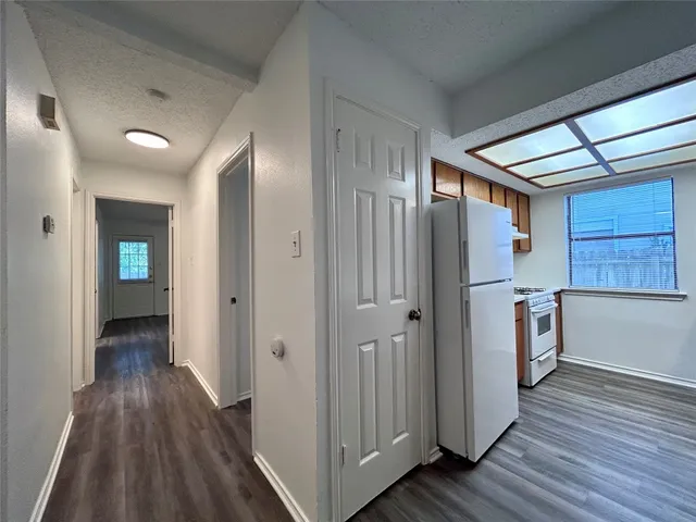 a view of hallway with wooden floor