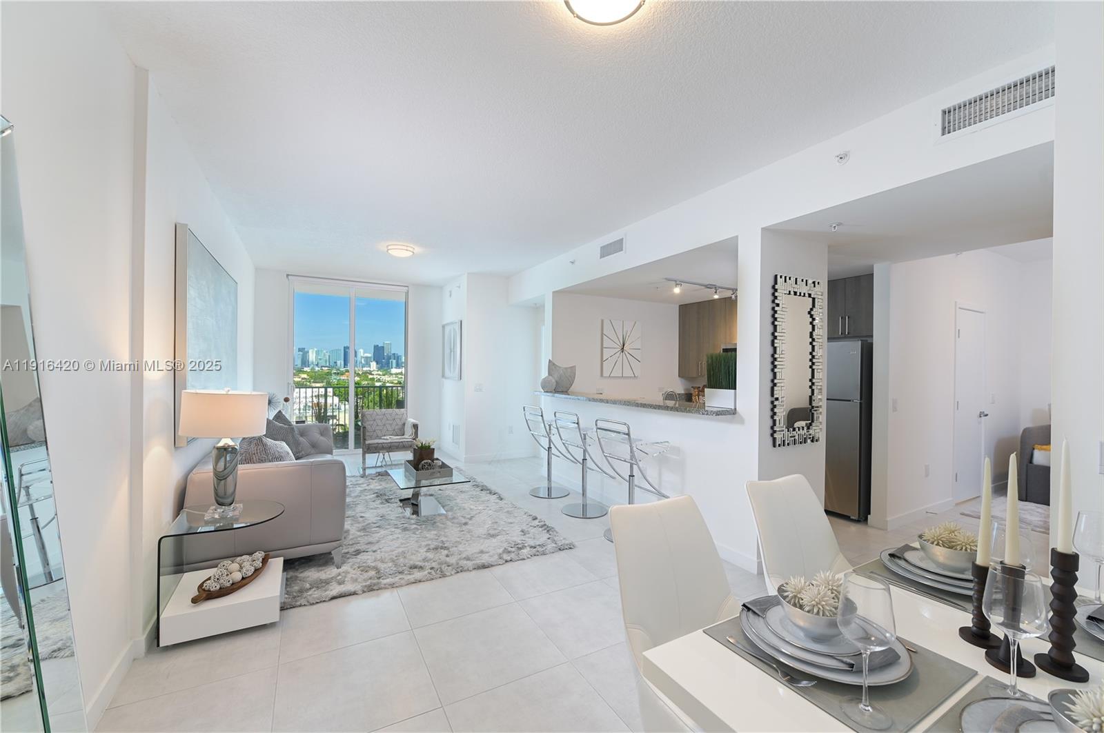514 Southwest 22nd Avenue, Unit 204 Miami, FL 33135 - Photo 1 of 22 a living room with furniture and a wooden floor