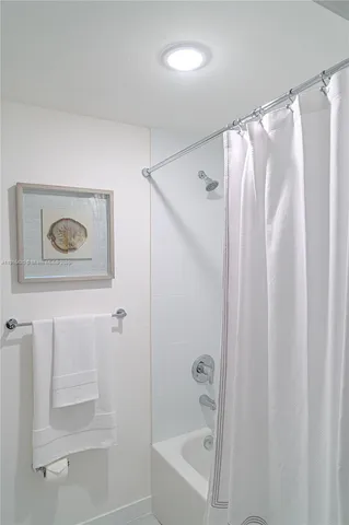 a bathroom with a shower and a tub