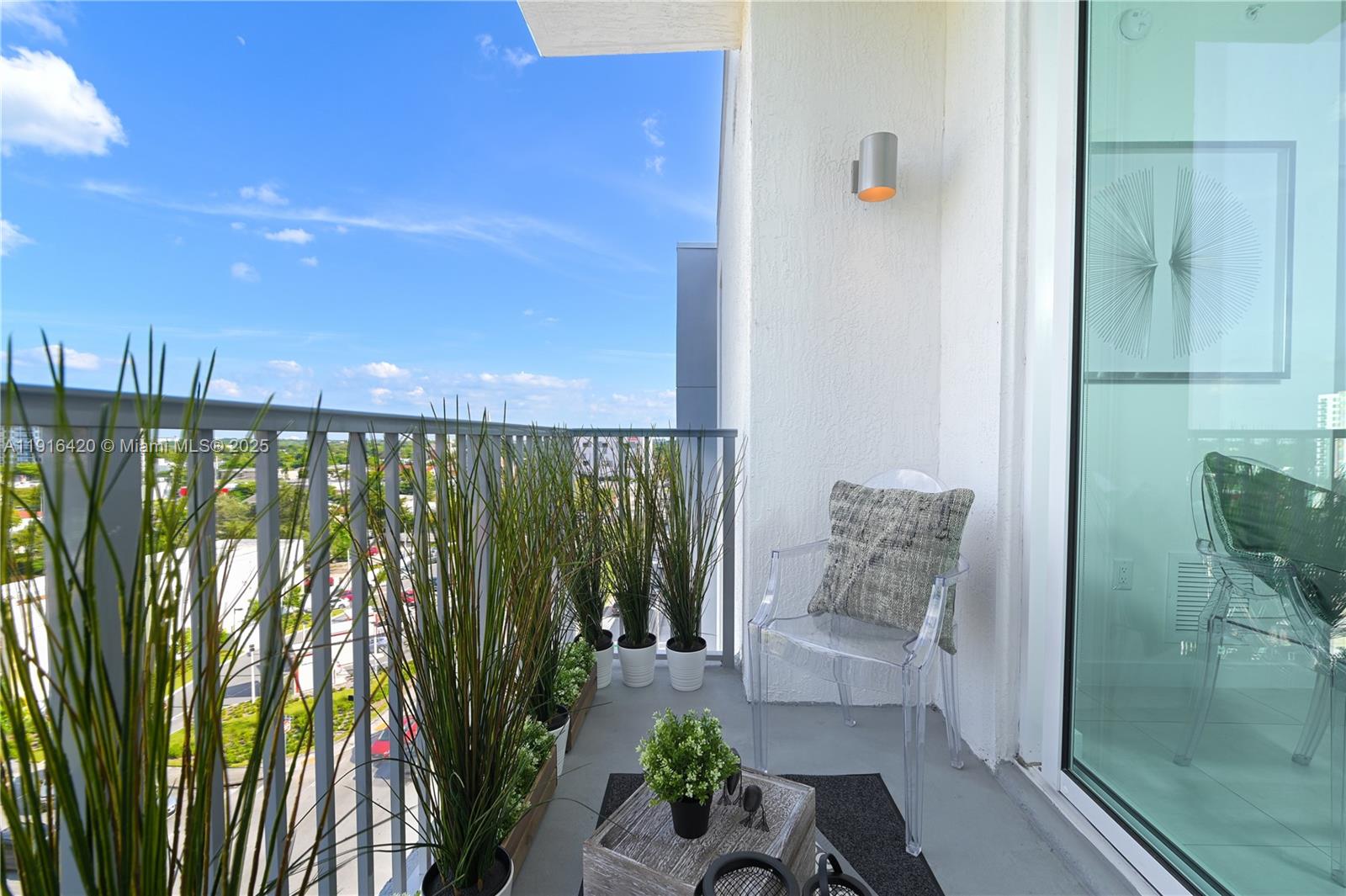514 Southwest 22nd Avenue, Unit 204 Miami, FL 33135 - Photo 22 of 22 a balcony with furniture and wooden floor