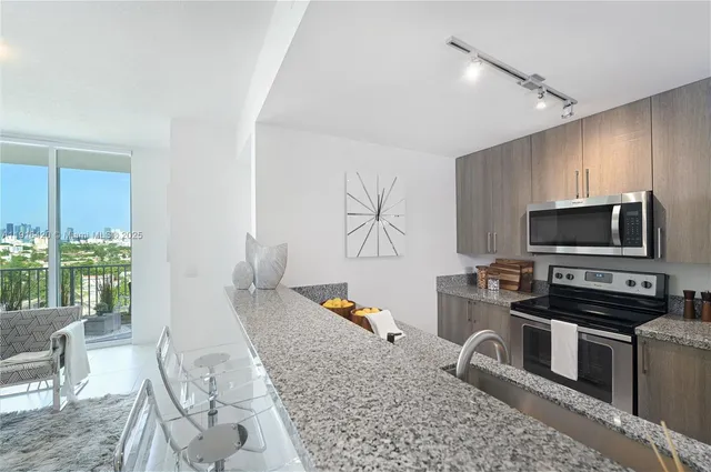 a living room with furniture appliances and a flat screen tv