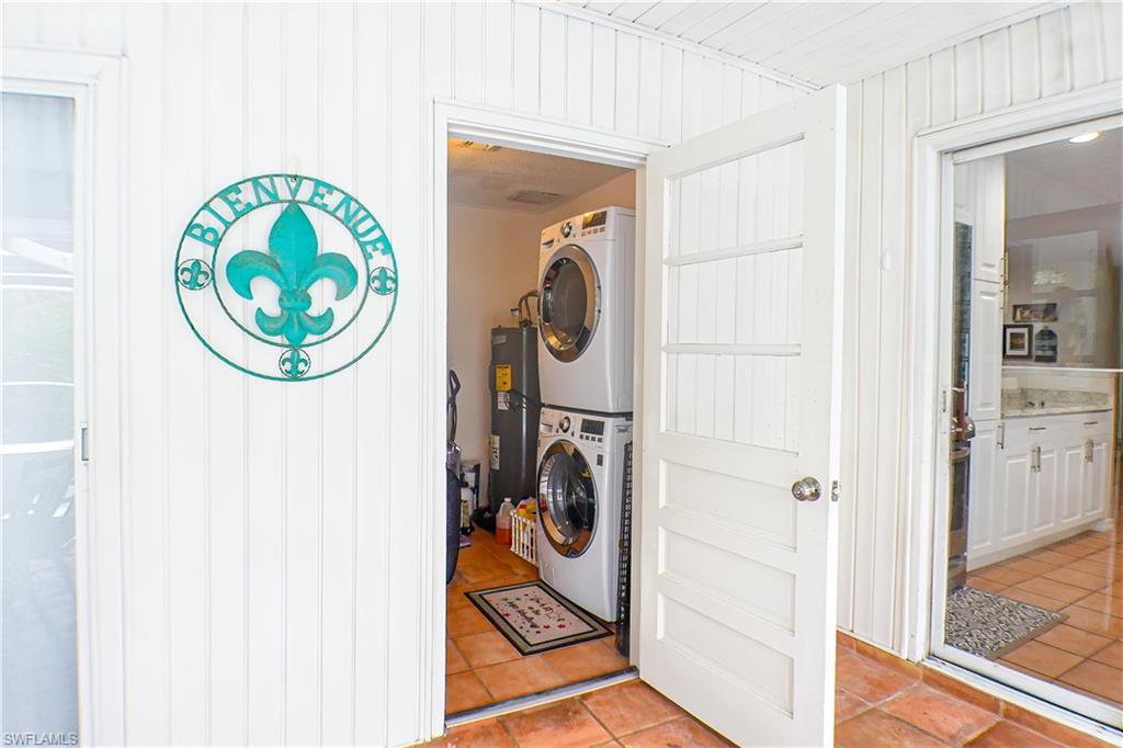 1056 Cardinal Street Naples, FL 34104 - Photo 14 of 32 Laundry room featuring stacked washer/dryer