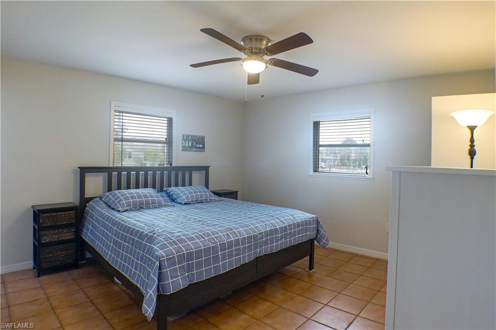 1056 Cardinal Street Naples, FL 34104 - Photo 17 of 32 Bedroom featuring tile floors, multiple windows, and ceiling fan