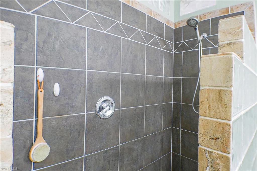 1056 Cardinal Street Naples, FL 34104 - Photo 25 of 32 Bathroom featuring a tile shower