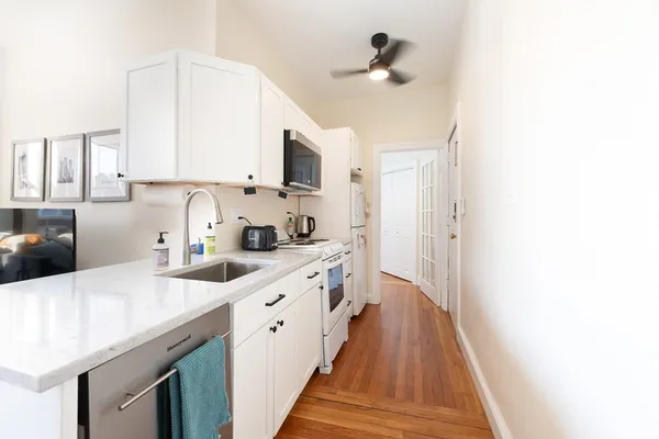 a kitchen with stainless steel appliances a refrigerator and a stove top oven