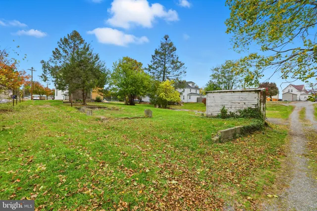 a view of a garden with a building in the background