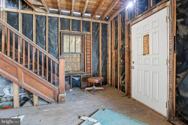 a view of a porch with furniture and front door