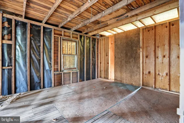 a view of a porch with wooden floor and a window