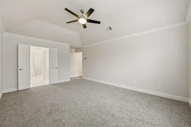an empty room with a ceiling fan and a window