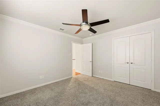 a view of a room with a ceiling fan