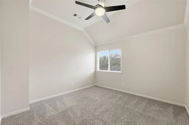 an empty room with a window and a ceiling fan