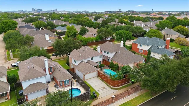 an aerial view of residential houses with outdoor space