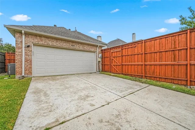 a view of a parking space in front of a house