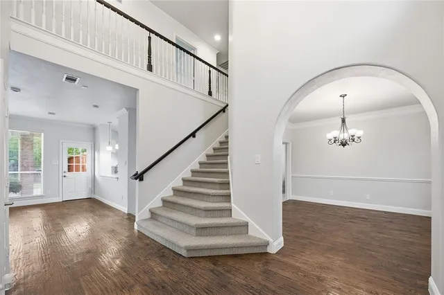 a view of entryway and hall with wooden floor