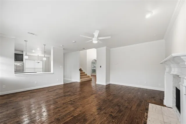a view of empty room with wooden floor and fireplace