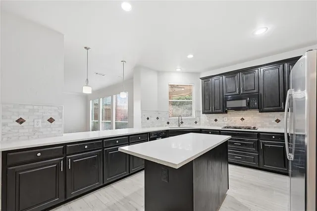 a kitchen with lots of counter space and a sink