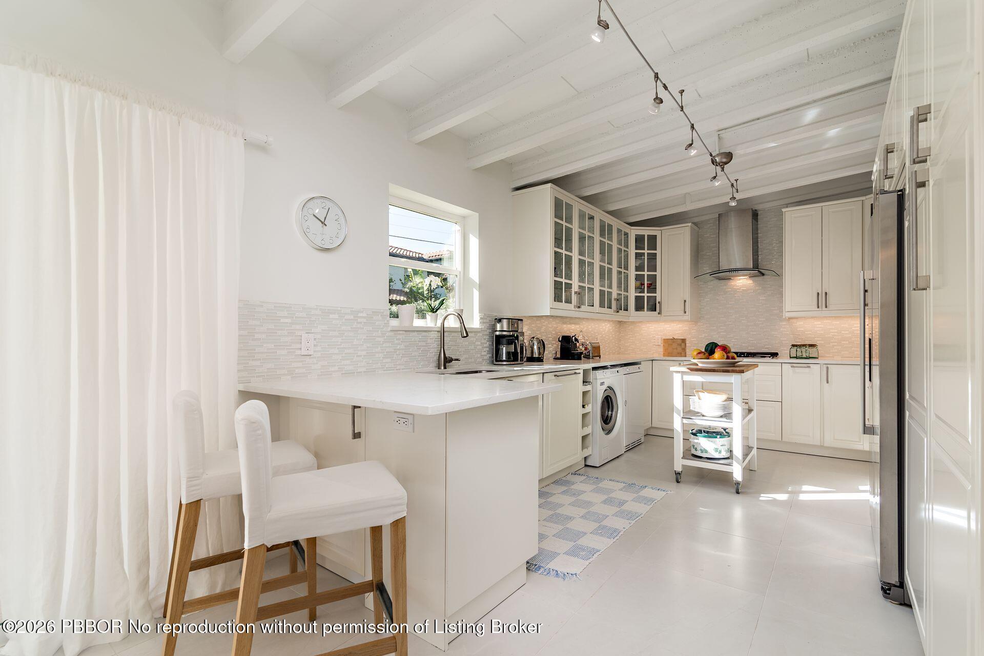 224 Churchill Road West Palm Beach, FL 33405 - Photo 10 of 33 a kitchen with table chairs cabinets and wooden floor