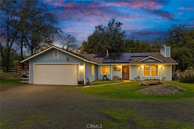 a view of a house with a yard and garage