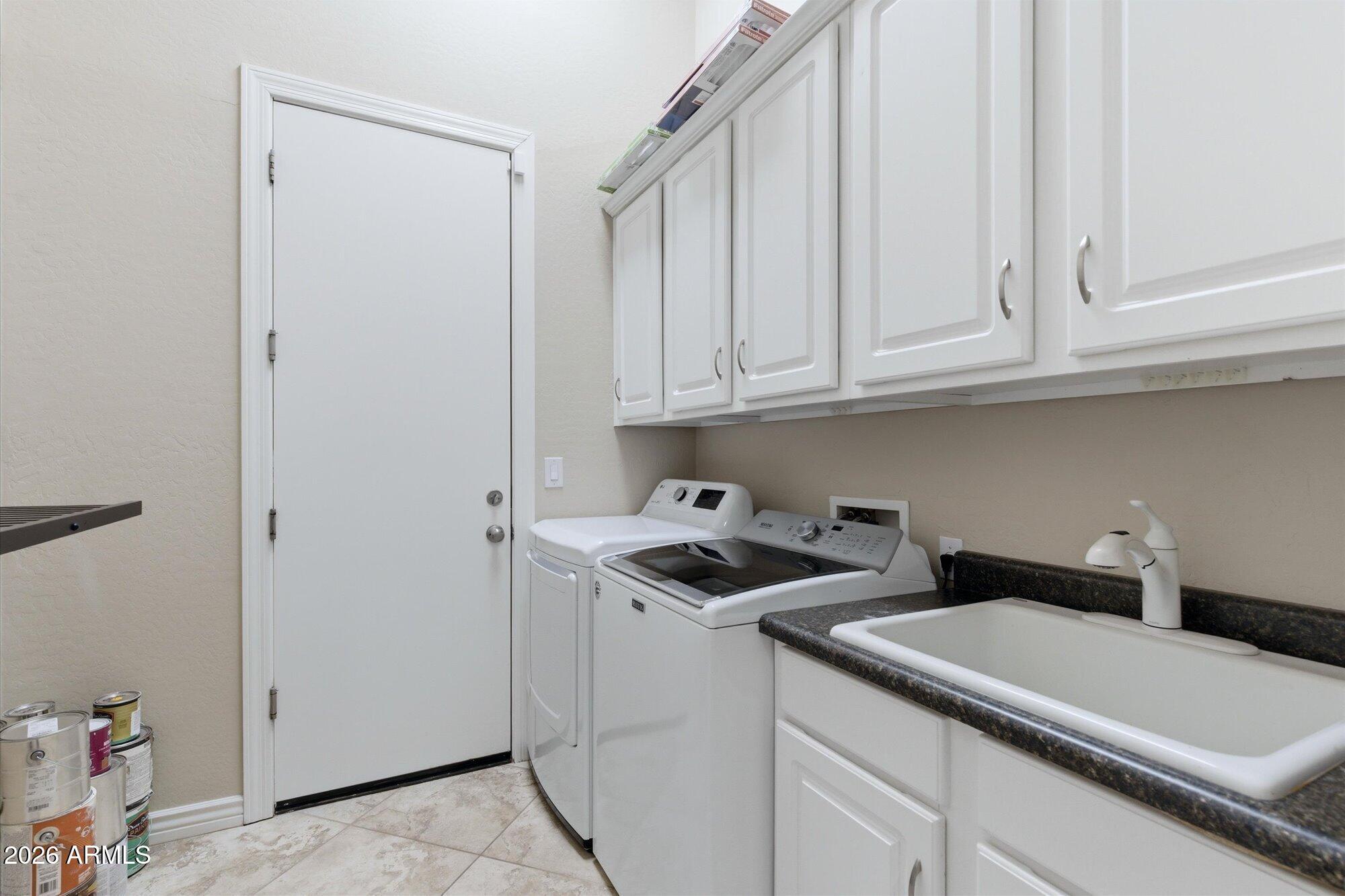 40322 North Hawk Ridge Trail Anthem, AZ 85086 - Photo 42 of 63 a kitchen with white cabinets and white appliances