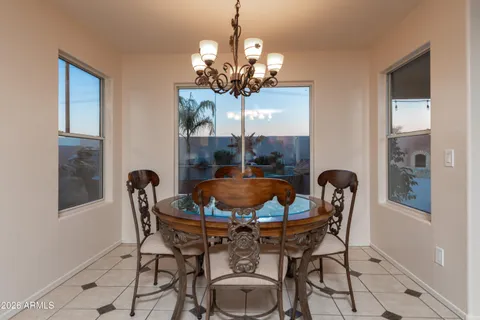 a dining room with furniture and chandelier