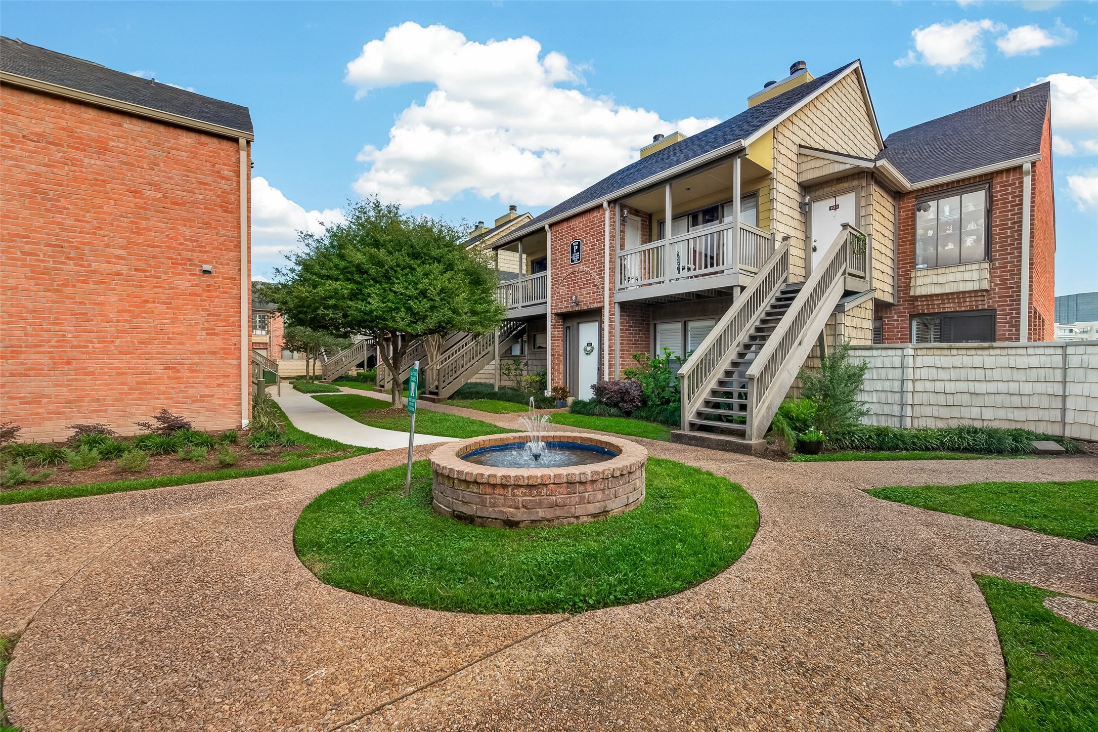2829 Timmons Lane, Unit 144 Houston, TX 77027 - Photo 28 of 41 The property includes well-maintained landscaping with a tree and shrubs.