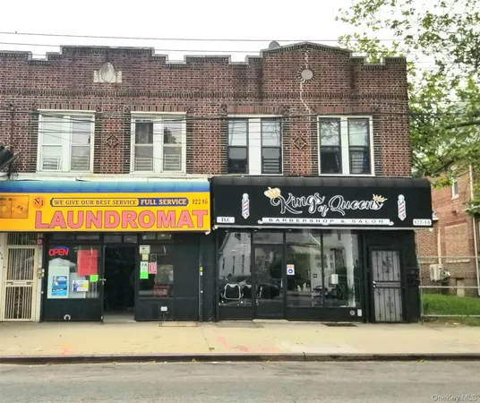 a front view of multi story building with retail shops