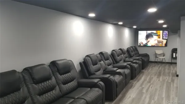 a media room with lots of chairs and a projector screen