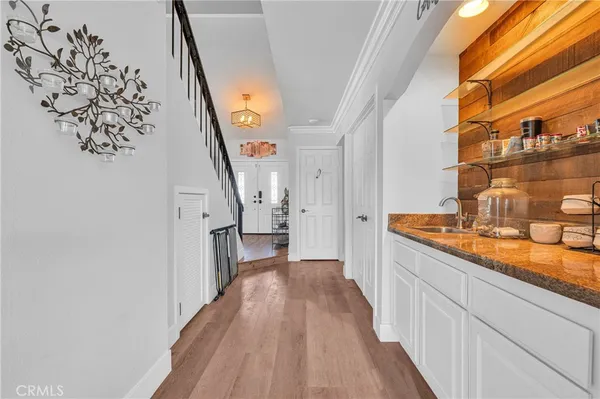 a living room with stainless steel appliances furniture and a kitchen view