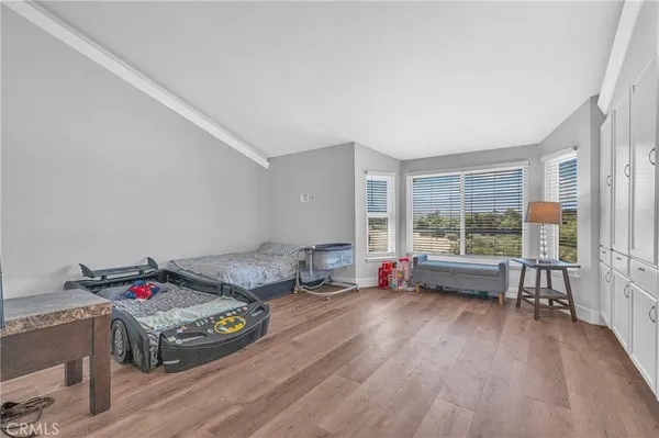 a bedroom with two beds and a window