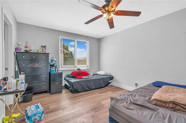 a bedroom with a bed and a bookshelf with wooden floor
